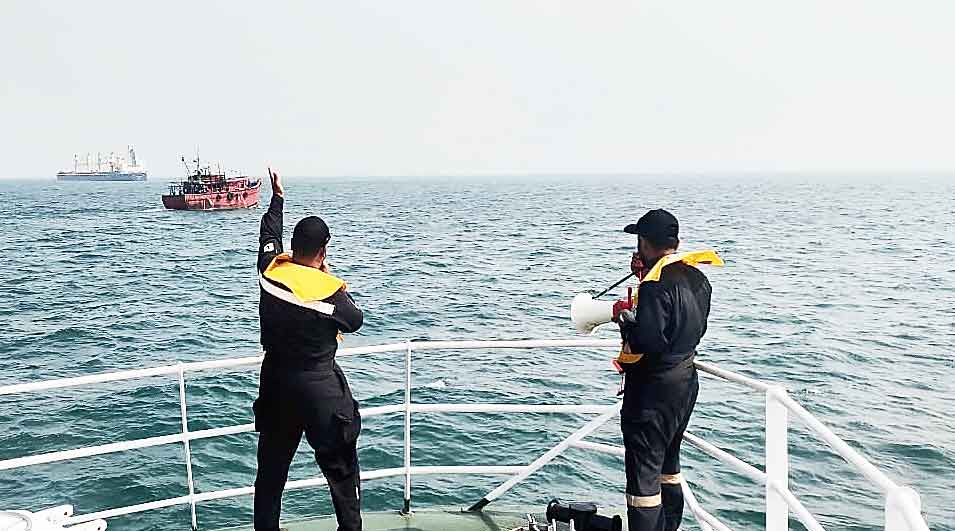 Coast Guard officers relay weather warnings on the Bay of Bengal on Wednesday.