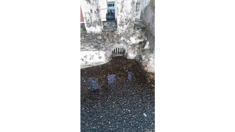 A pool of water formed on the rooftop with the outlet jammed with soil.