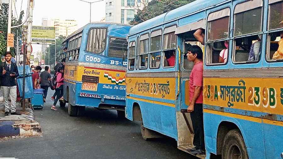 Private buses pick up daily commuters from Sector V on Wednesday afternoon. 