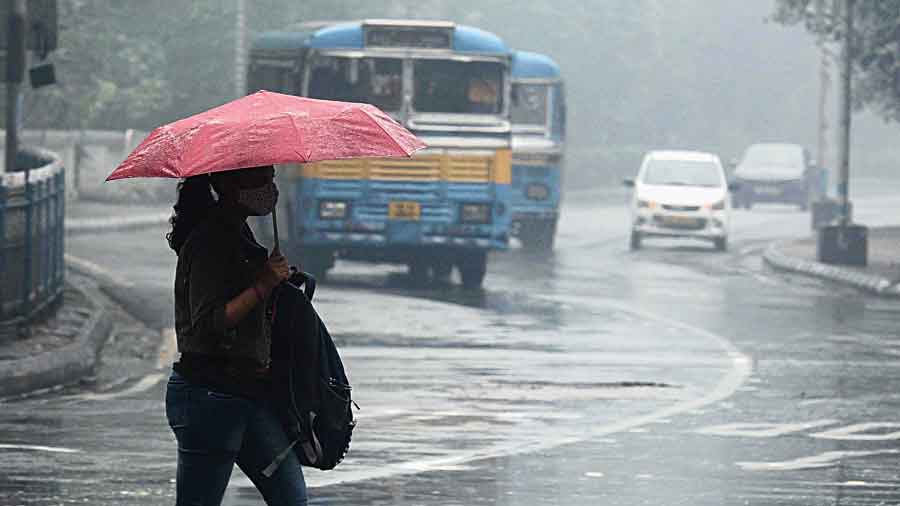 A pedestrian crosses Outram Road amid rain on  Saturday afternoon.