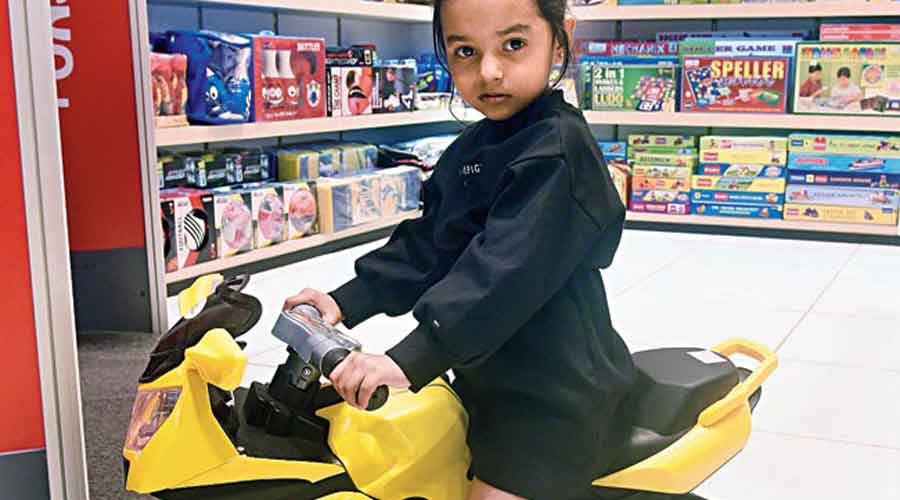 Three-year-old and older Inaya Bose was busy riding a battery-operated yellow bicycle in the store.  7,499 rupees.