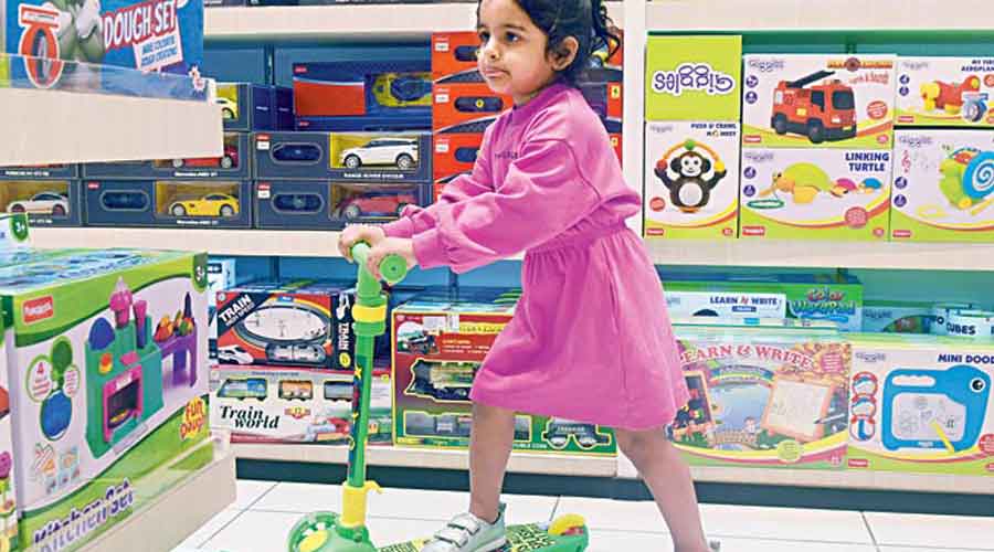 Three-year-old Naisha Bose was making the most of her playtime at the store riding a Green LED light scooty. Rs 2,495.