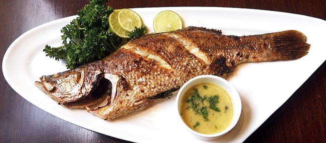 Roasted Whole Beckty in Lemon Butter Sauce: A meal in Calcutta is always incomplete without some maachh. This roasted whole bekti, served with fragrant lemon-butter sauce on the side, is for all the mechho-Calcuttans.