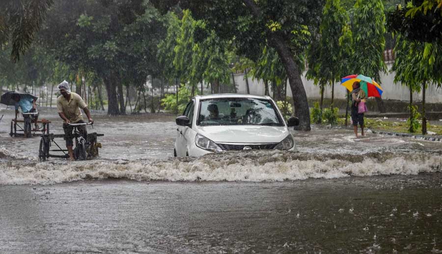 A car negotiates a waterlogged stretch near Haldiram's crossing on VIP Road on Monday morning. After a night of incessant drizzle, Kolkata woke up to an overcast sky and more rain on Monday. According to the India Meteorological Department (IMD), Cyclone Jawad has weakened into a depression over the northwest Bay of Bengal near the Odisha coast on Sunday