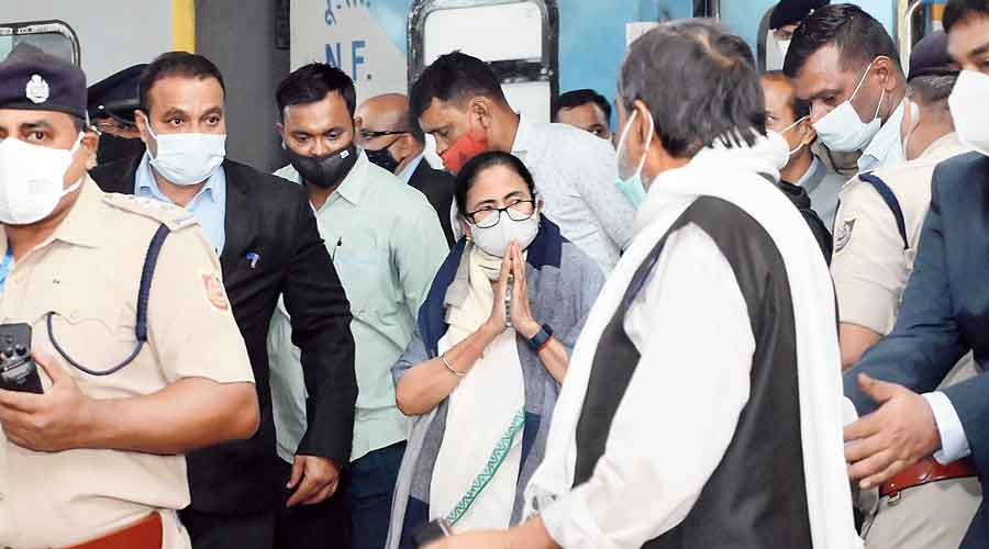 Chief minister Mamata Banerjee greets people after arriving at Malda Town station on Monday evening. 
