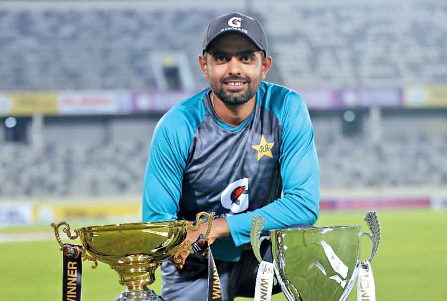 Pakistan captain Babar Azam poses with the T20I  and Test series trophies on Wednesday.