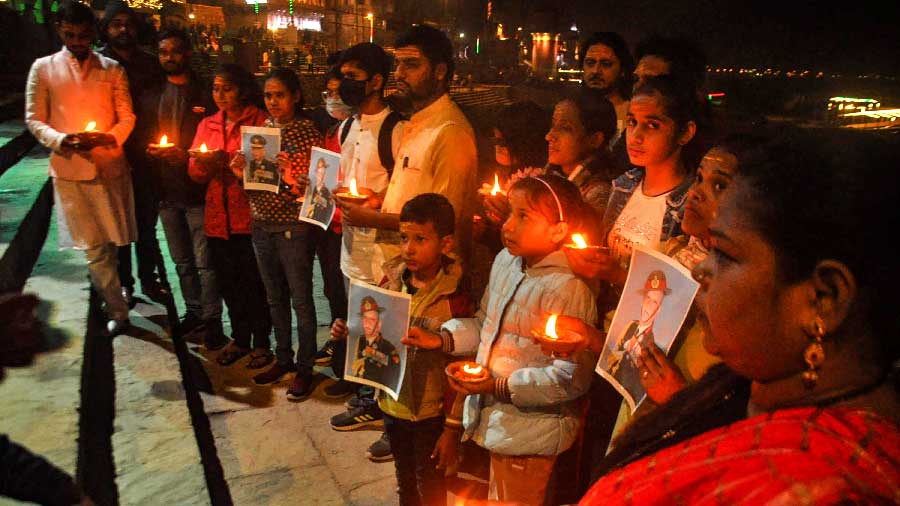 People pay homage to those killed in an IAF chopper crash, in Varanasi on Wednesday.