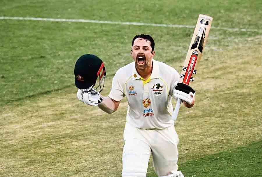 Travis Head exults after completing his century on Day II of the first Ashes Test against England at  the Gabba.