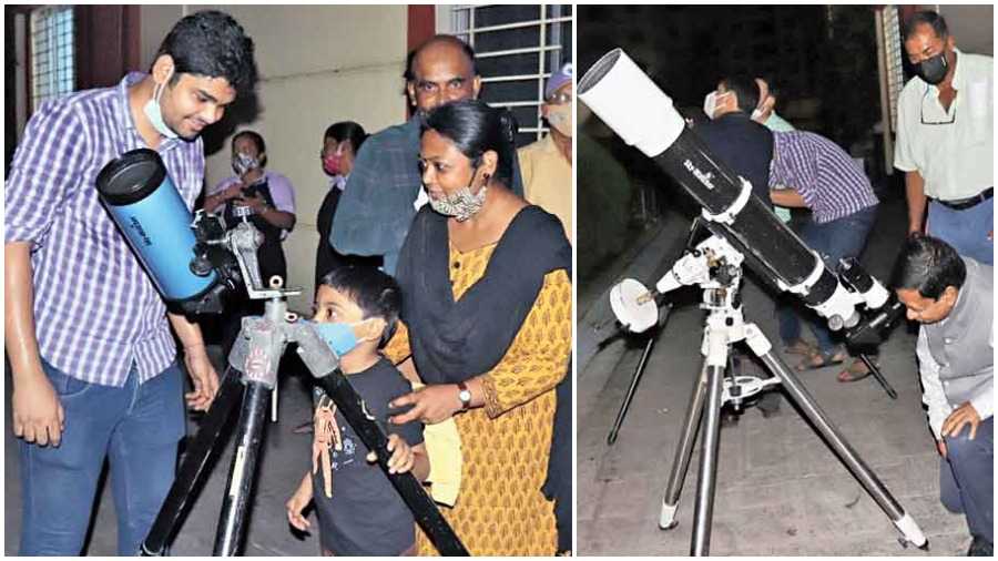 A child prepares to look at Jupiter through a telescope at New Town Business Club; Hidco chief Debashis Sen observes Saturn and its rings through a different telescope