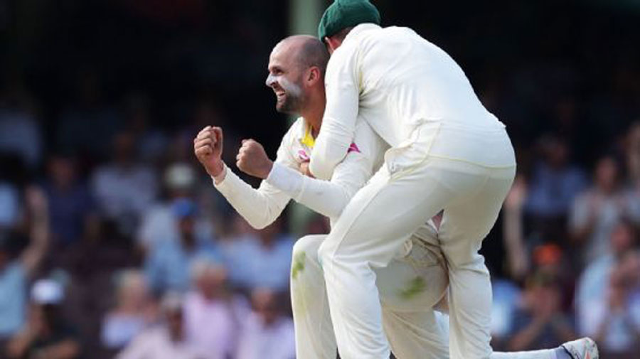 Australia's Nathan Lyon celebrates a wicket with his teammate, in Brisbane on Saturday.