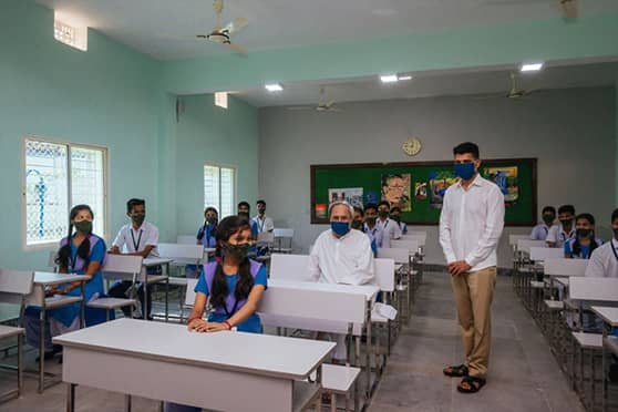 Odisha chief minister Naveen Patnaik seated with Class X students of Brundaban Government High School in Hinjili, Ganjam, during an inspection.