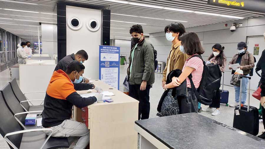 Swab samples being collected from international fliers before immigration clearance at Kolkata airport