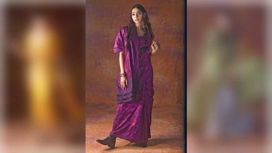 This regal purple Benarasi sari styled with a local draping style imitates a colour palette of the changing colours of the sky at dusk in Ladakh. The sari woven with intricate motifs give a lush texture to the ensemble. Dramatic eyes complete the look.