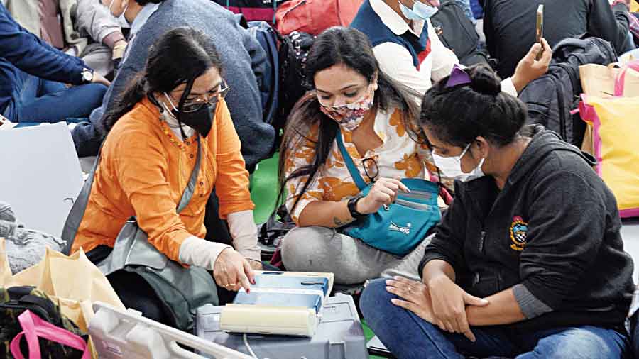 Poll personnel check EVMs at David Hare Training College in Ballygunge on Saturday.