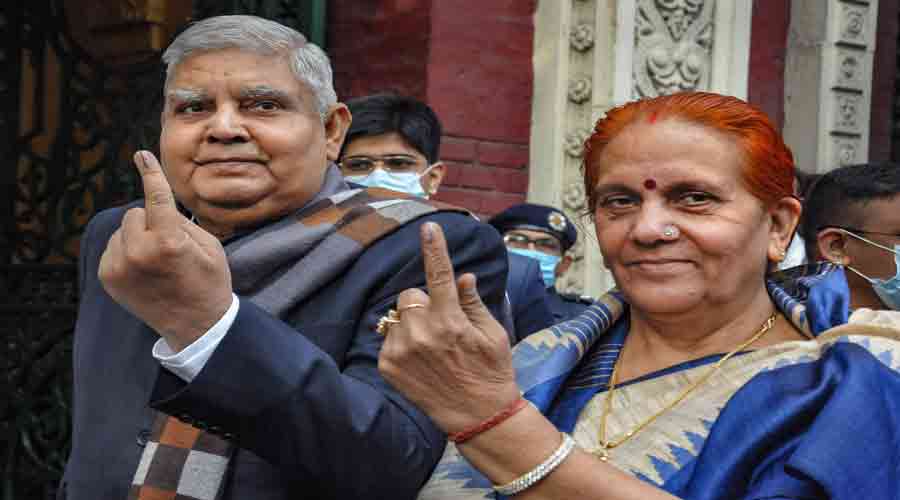 Governor Jagdeep Dhankhar with his wife Sudesh Dhankhar (R) after casting their vote during Kolkata Municipal Corporation (KMC) elections, in Kolkata, on Sunday.