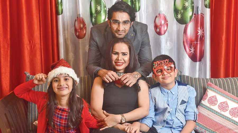 This frame was all about ‘we are family’, all set for Christmas. Jessica picked a black dress, red shoes, red lips and a red neckpiece. Black smokey eyes complemented the look. Neeraj had a formal touch to his attire. The kids looked oh-so-cute! “You need that hint of red on Christmas... maybe I would wrap a shawl or shrug on Christmas Day. I try to maintain the same for the kids... a hint of red, checks, the waistcoat. It’s the way we grew up... the socks and the shoes...the glasses and the Christmas hat. For kids, the colours will never be black. We have always known black, grey and purple are colours for old people! Neeraj is too stylish for anyone to decide, but I am particular about that touch of tradition!” said Jessica.