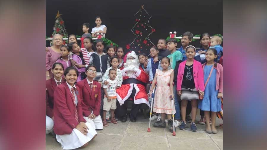 Georgie Guha, as Santa, is invariably the centre of attention at Dalhousie Institute's annual Christmas programme for underprivileged kids 