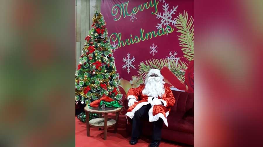 Guha, all decked up, posing with the Christmas tree