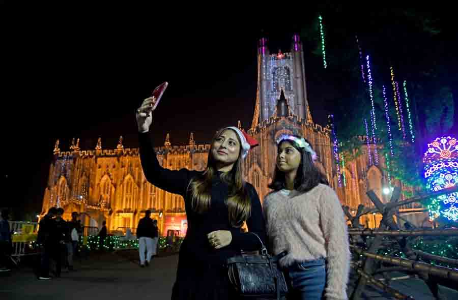 A woman and a child pose for a selfie in front of St Paul’s Cathedral on Christmas Eve. Revellers flocked to the St Paul’s Cathedral to be part of the Midnight Mass service and celebrations