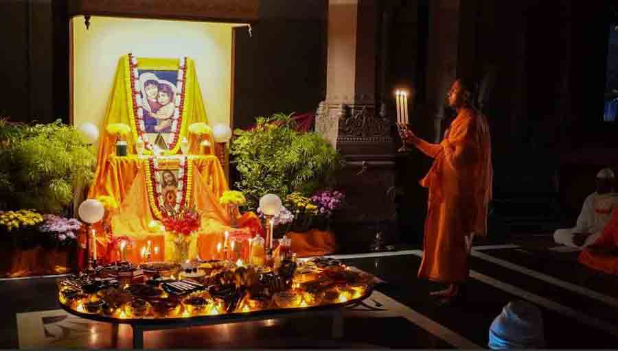A monk performs rituals at the Ramakrishna Mission world headquarters at Belur in Howrah district on Christmas Eve on Friday. Across all centres of Ramakrishna Math and Ramakrishna Mission, the evening is marked by carol singing, candle lighting, prayers and offering of cakes.  After Sri Ramakrishna Paramhansa attained ‘mahasamadhi’ in 1886, Swami Vivekananda (at that time Narendranath) and some of his monastic brothers had gathered at Antpur in Hooghly district in December the same year. One night, Swamiji sat with his brothers before a fire the whole night and exhorted them to take ‘sannyasa’ in the tradition of great renunciates.  In the morning they came to know it was Christmas Eve. Eventually, they took ‘sannyasa’, and the organisation was formed. In remembrance of that great beginning, Christmas Eve is treated as a sacred day by the monks and devotees of Ramakrishna Sangha