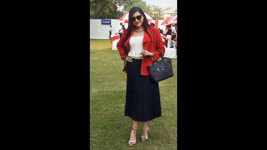 Adolina Ganguly dressed smart and elegant in a red jacket, paired with a white top and ankle-length pleated skirt from Zara.