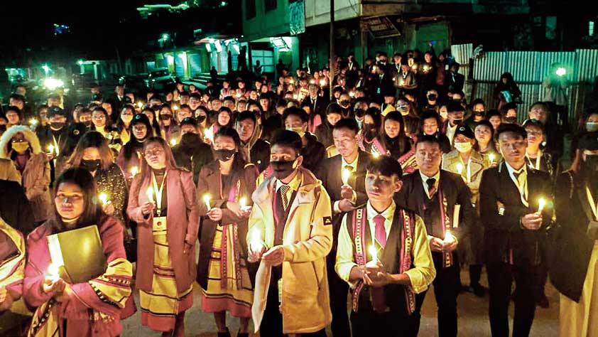 Locals participate in a candle march over the death of 13 people, who were allegedly killed by Armed Forces, in Mon district, Sunday night, Dec. 5, 2021.