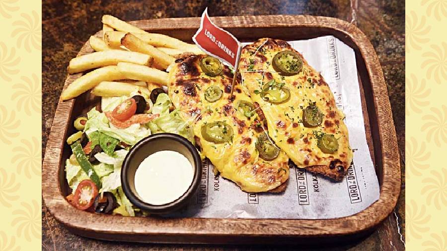 Classic Parmo: These breaded chicken cutlets are juicy and the layer of cheese sauce on top adds to the mouth-melting flavours. With the fries and veggies, it makes for a fulfilling meal. Rs 545