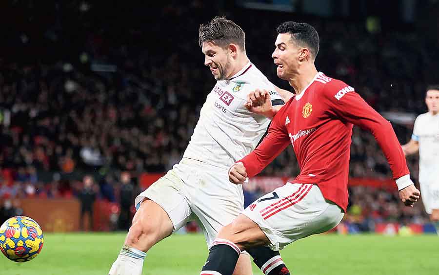 Cristiano Ronaldo (right) of Manchester United is challenged by James Tarkowski of Burnley at Old Trafford on Thursday.