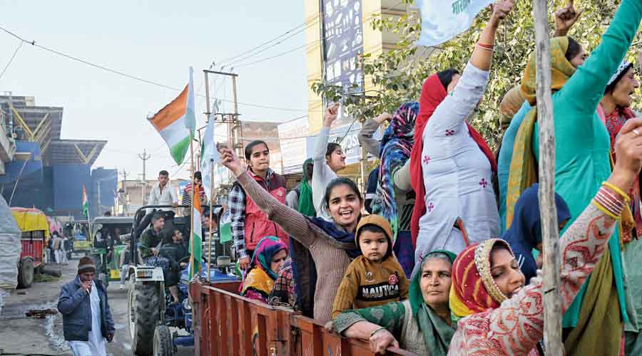 Women and children from Haryana and Punjab arrive  on tractors at the Tikri border