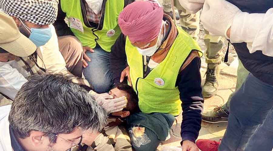 Volunteers give first aid to a CISF jawan at Nangloi in west Delhi on Republic Day