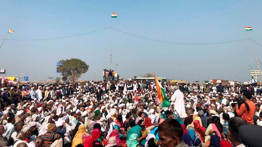 Farmers block a highway in Palwal, Haryana, during there three-hour long 'chakka jam' on Saturday against the Centre's three new farm laws.