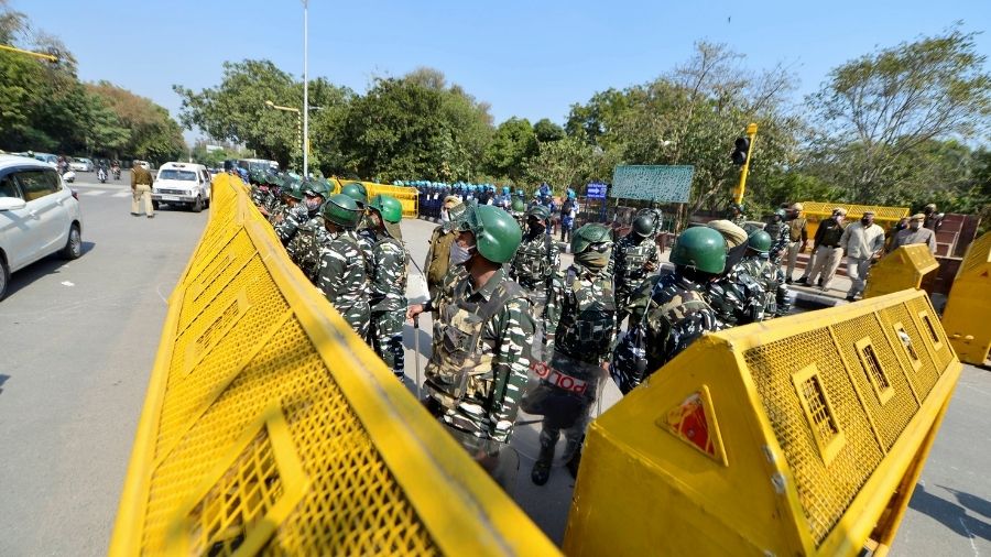 Police and security personnel stand guard at the national capital. Security has been tightened in Delhi after the break out of clashes during farmers' tractor rally on January 26.