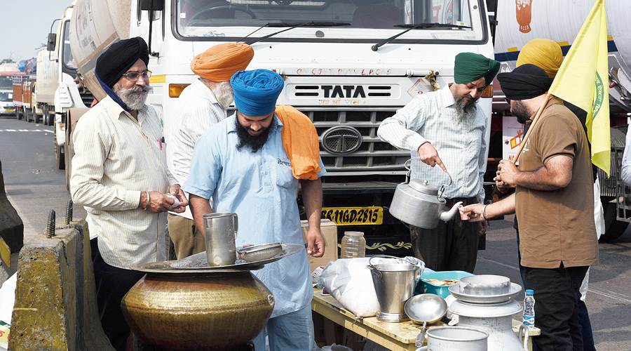 Demonstrators offer tea to truck drivers and others who got stuck because of the blockade.