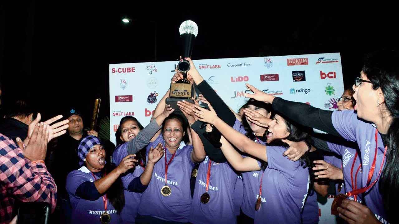 The victorious Mystic Maya team exults with the trophy.