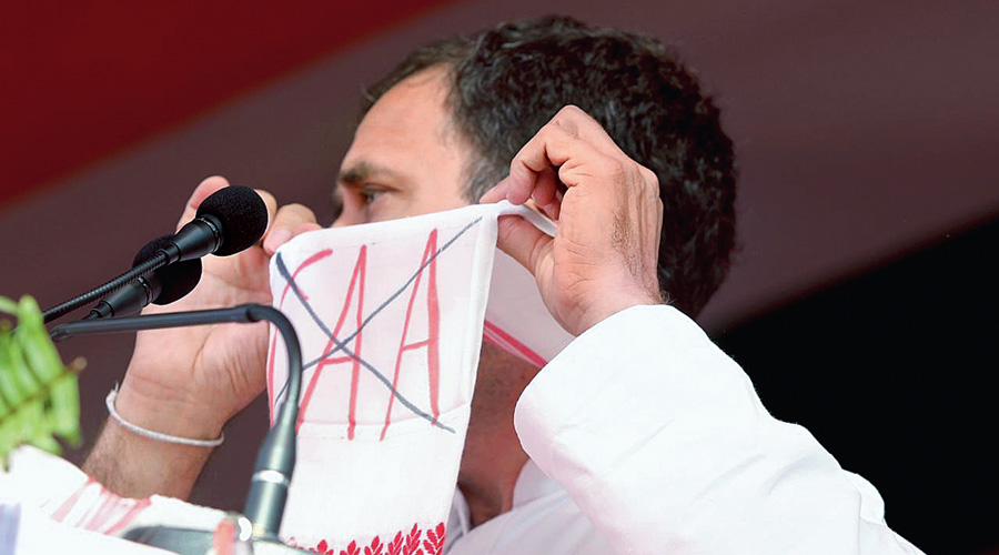 Rahul Gandhi shows the anti-CAA message on the gamucha (traditional Assamese towel) at the Sivasagar rally.