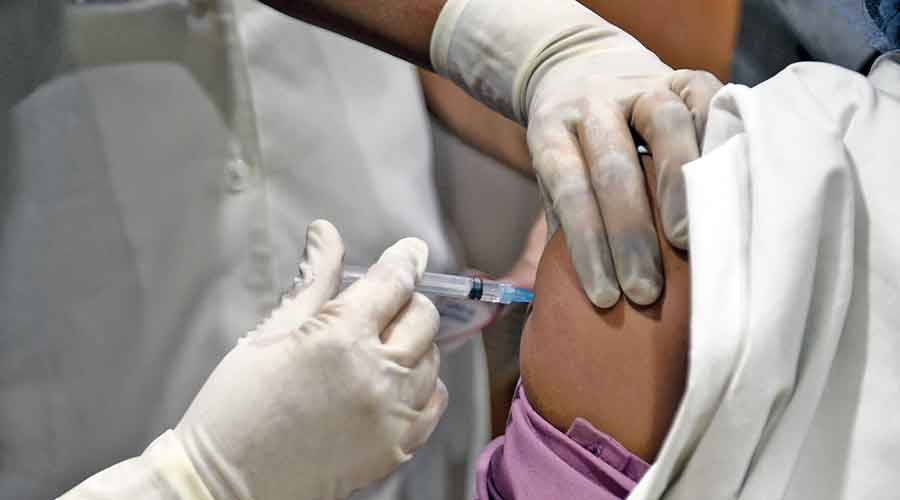 A health worker in the city gets  a Covid-19 vaccine shot