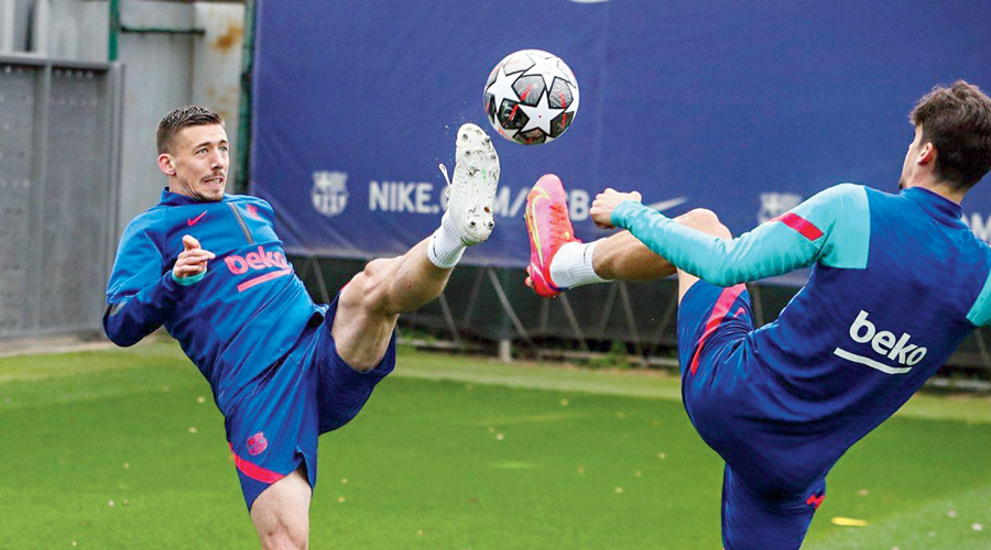 Barcelona defender Clément Lenglet (left) and teammate during a training  session on Monday. Barcelona host Paris Saint-Germain in a Round-of-16  Champions League first-leg match on Tuesday.