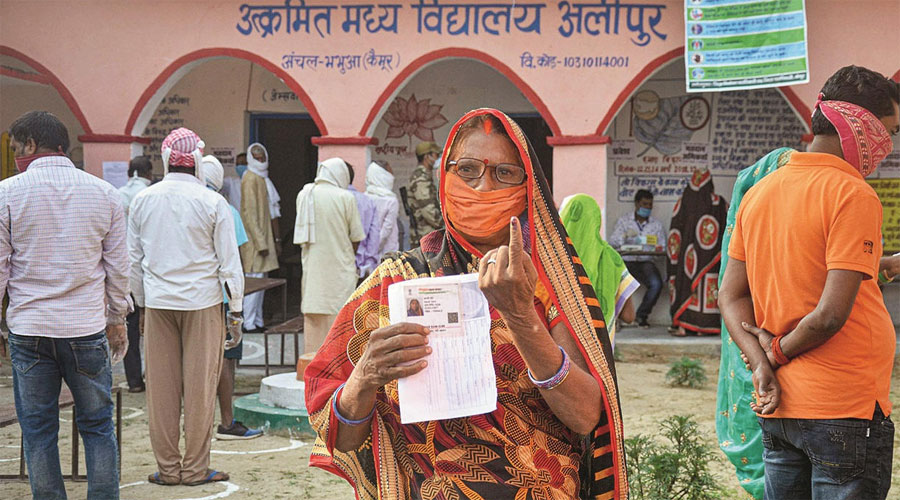 A voter shows her finger marked with indelible ink after casting her vote for the first phase of Bihar Assembly Election, amid the coronavirus pandemic, at Bhabhua police station in Kaimur district on Wednesday, Oct. 28, 2020.