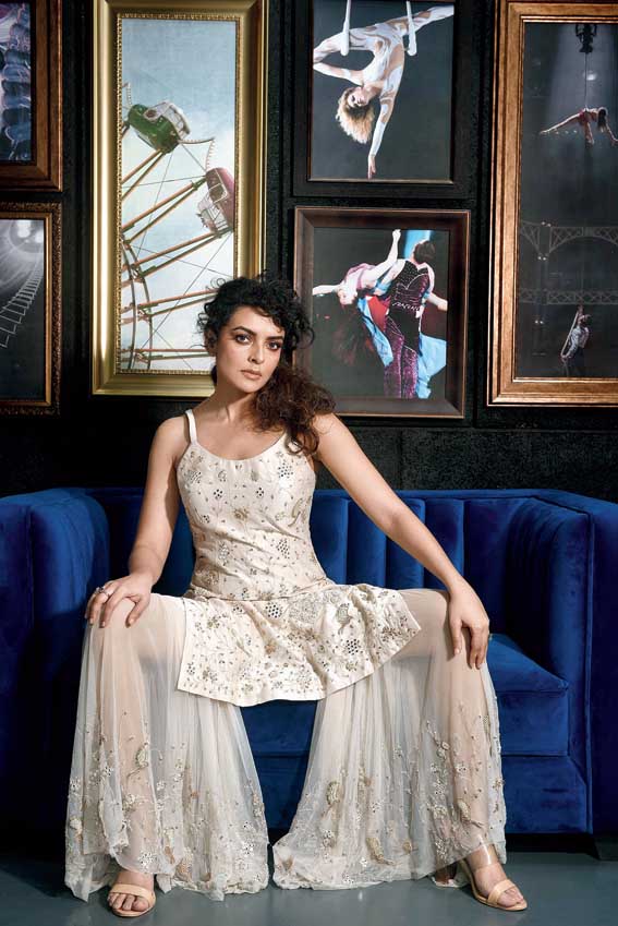 Bidita looked delicate pretty in an off-white spaghetti kurta with hand embroidery, teamed with an embroidered sheer net gharara.