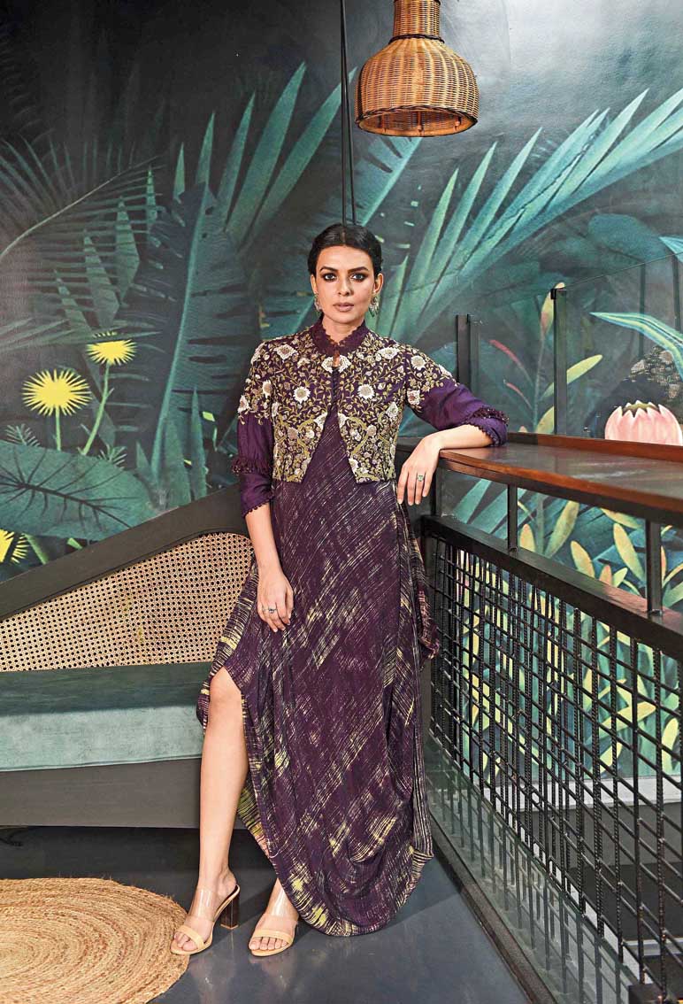 This aubergine drape with a print on it has been paired with a short embroidered jacket. #subtlecharm