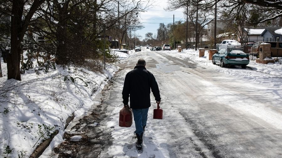 A man goes out to fill fuel for his generator amid freezing weather conditions in Austin, Texas on Tuesday.