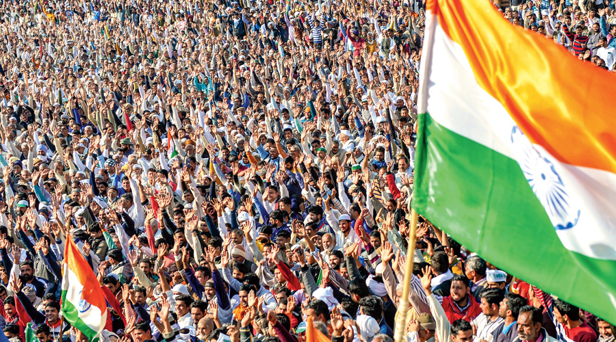 Farmers holding the national flag attend the Kisan Mahapanchayat in Uttar Pradesh’s Shamli district on February 5.