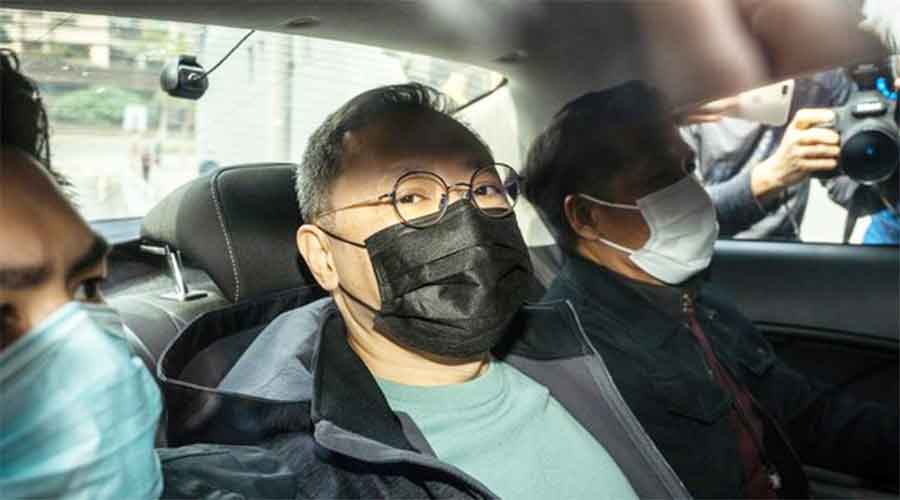 Pro-democracy activist Benny Tai arrives at a police station in Hong Kong after his arrest on Wednesday.