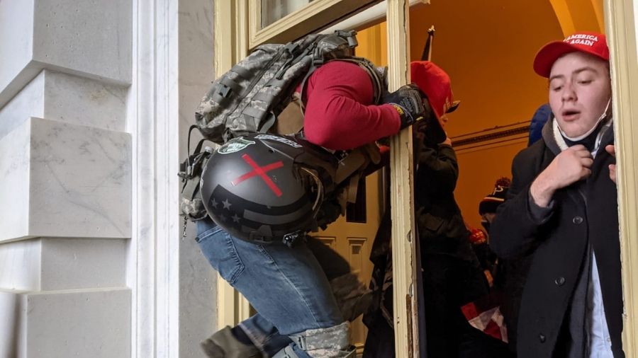 A protester gets inside the US Capitol building through a window, on Wednesday, in Washington.