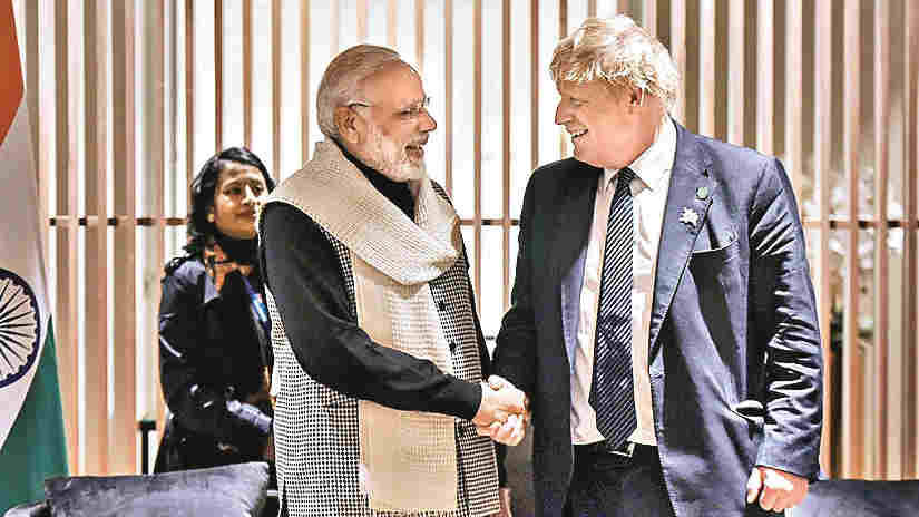 In this April 17, 2018 file photo, Prime Minister Narendra Modi shakes hands with then Britain Foreign Secretary Boris Johnson on his arrival, at London airport.