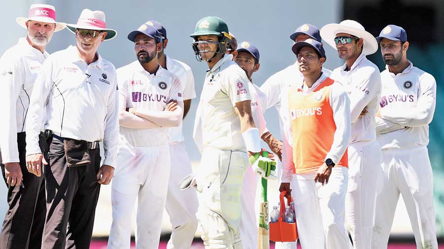 Tim Paine, alongwith India players and umpires Paul Reiffel and Paul Wilson, during suspension of play  following Mohammed Siraj’s complaint of racial  abuse on Sunday. 