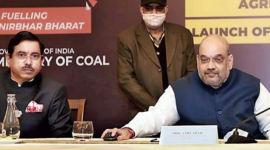 Amit Shah with coal minister Pralhad Joshi in New Delhi on Monday.