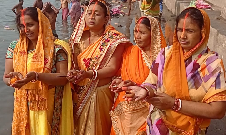 Women pray to the Sun God on the banks of river Damodar at Mohalbani Ghat in Dhanbad on Thursday.