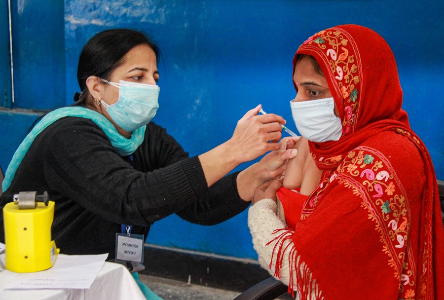 A medic administers the first dose of COVID-19 vaccine to a frontline worker, at Government Girls School in Gurugram.