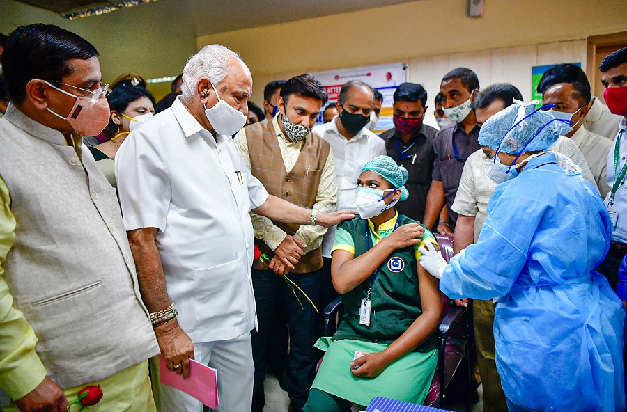 A medic administers the first dose of Covishield vaccine to a health worker in the presence of Karnataka CM BS Yediyurappa, in Bengaluru.
